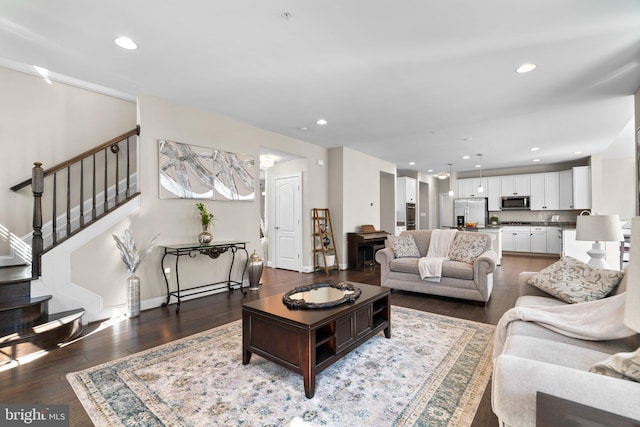 living room featuring recessed lighting, stairs, and wood finished floors