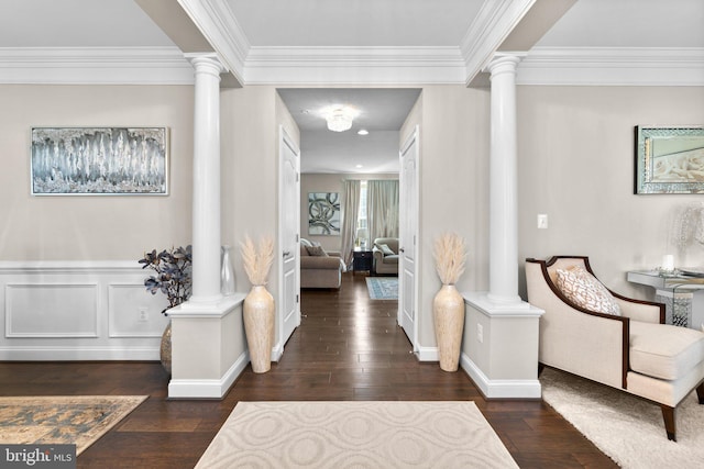 hallway featuring crown molding, ornate columns, and hardwood / wood-style flooring