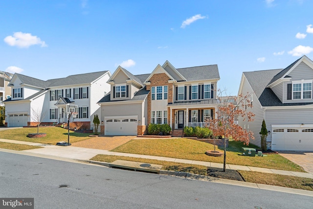 view of front of home featuring brick siding, a residential view, a front yard, decorative driveway, and a garage