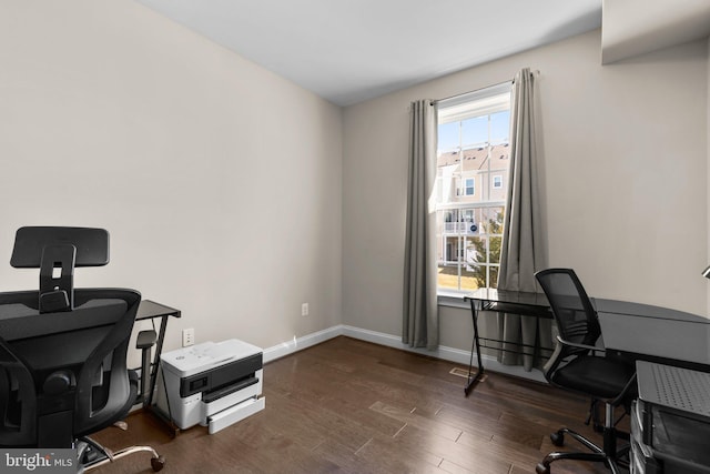 home office with baseboards and dark wood-style flooring