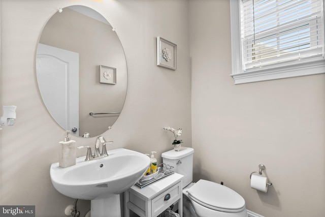 bathroom with toilet and a sink