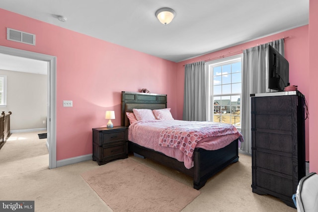 bedroom with light carpet, visible vents, and baseboards