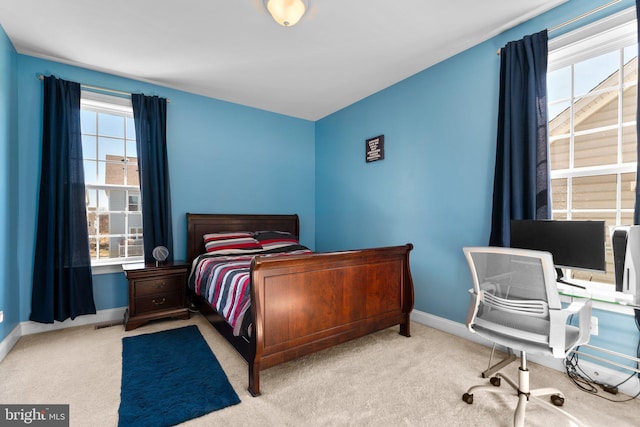 carpeted bedroom with baseboards