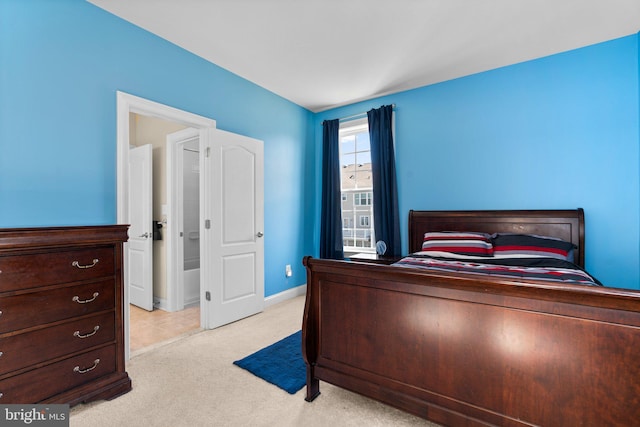 bedroom with light carpet and baseboards