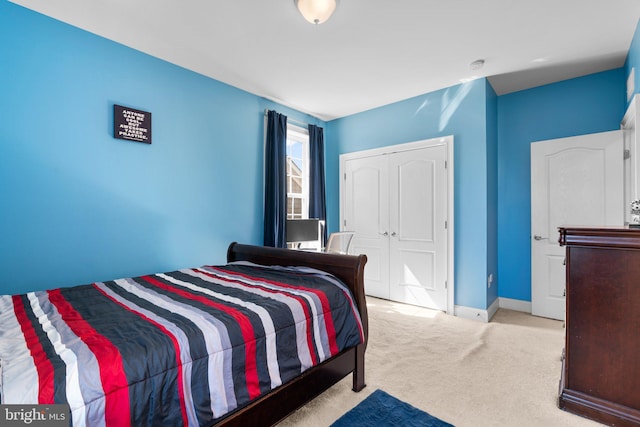 carpeted bedroom featuring baseboards