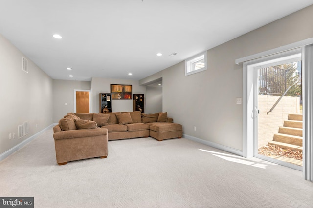 living area featuring visible vents, baseboards, and carpet