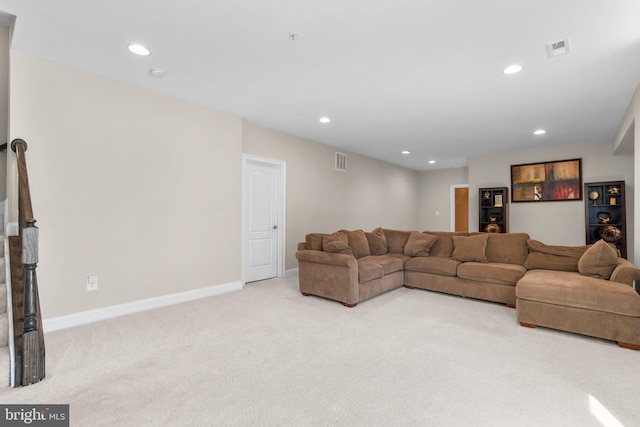 living room with recessed lighting, visible vents, baseboards, and light colored carpet