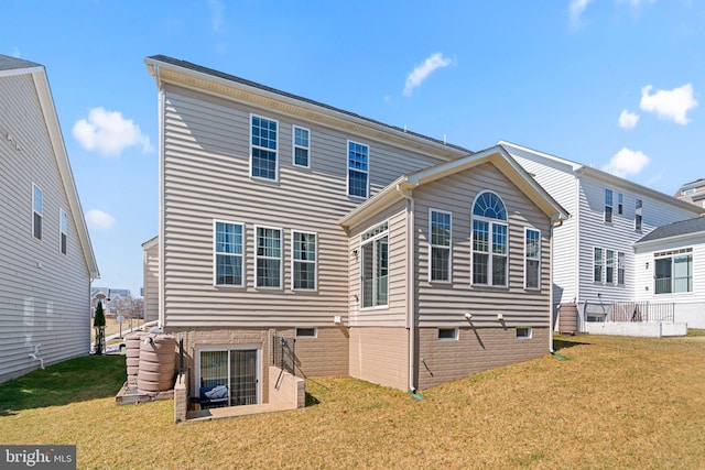 rear view of property with a lawn