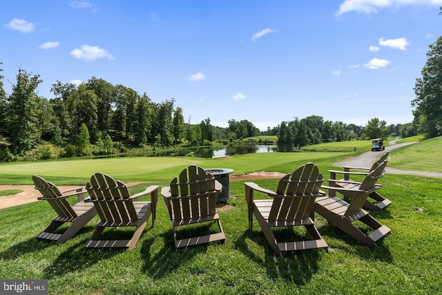 view of yard featuring golf course view and a water view