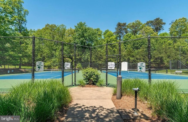 view of sport court featuring a gate and fence