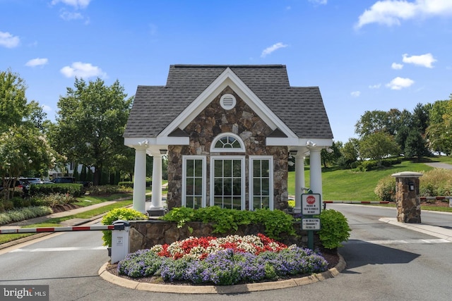 surrounding community featuring an outdoor structure and a yard