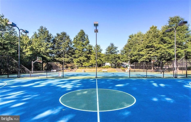 view of basketball court with community basketball court and fence