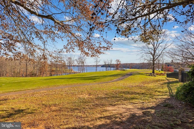 view of yard featuring fence and a water view