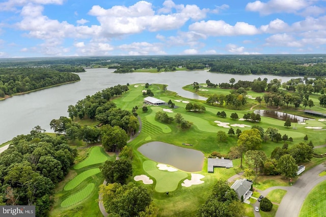 birds eye view of property with golf course view and a water view