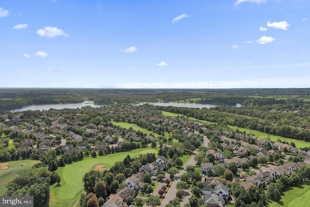 drone / aerial view featuring view of golf course, a water view, and a residential view