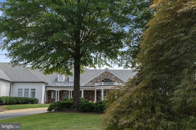 view of front of home featuring a front yard and stone siding