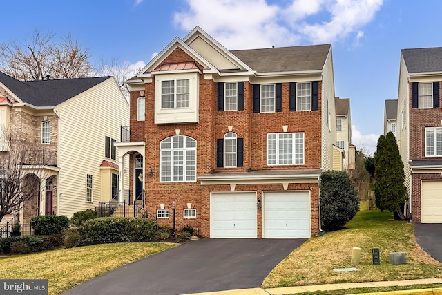 view of front of property featuring aphalt driveway, a front lawn, a garage, and brick siding