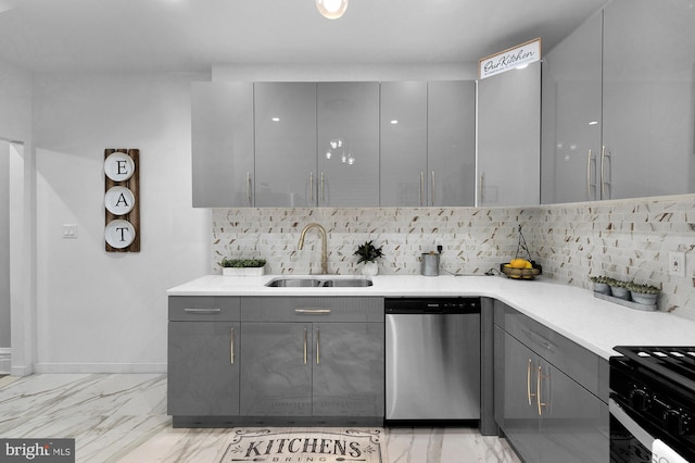 kitchen with a sink, stainless steel dishwasher, and gray cabinetry