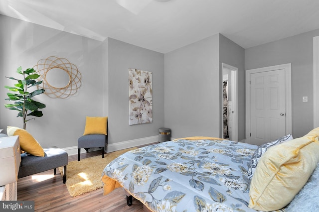 bedroom with baseboards and wood finished floors