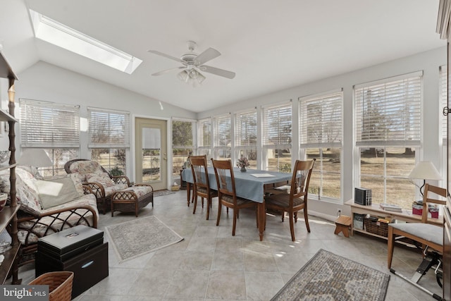 sunroom / solarium featuring lofted ceiling with skylight and a ceiling fan