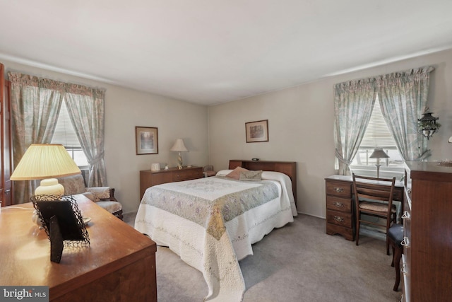 carpeted bedroom featuring multiple windows