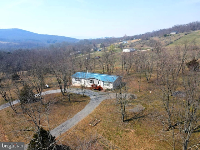 aerial view featuring a rural view, a mountain view, and a wooded view