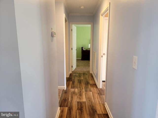 hall with baseboards, dark wood-style flooring, and crown molding