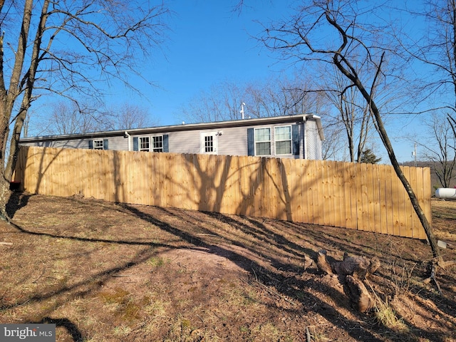 rear view of property with fence