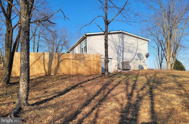 view of side of home featuring fence