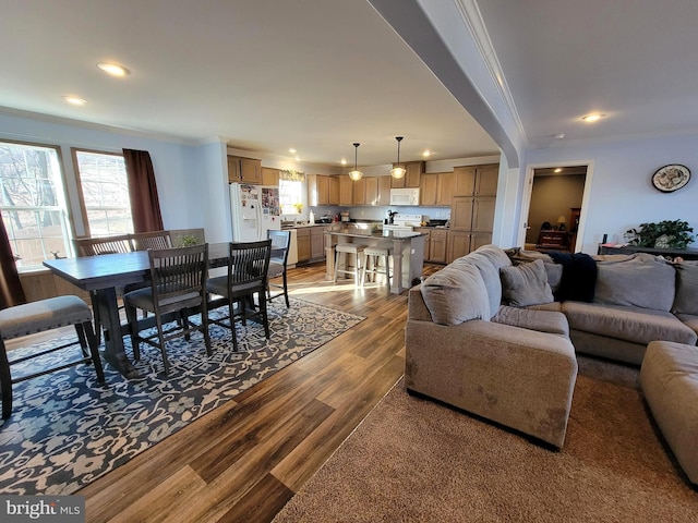 living room featuring recessed lighting, wood finished floors, and ornamental molding