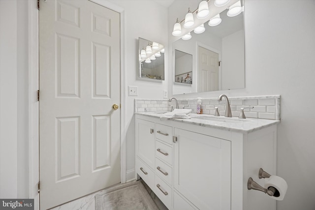 full bathroom featuring decorative backsplash, double vanity, and a sink