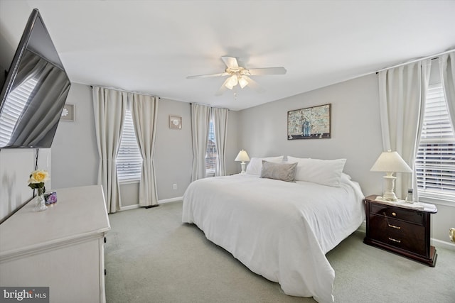 bedroom with baseboards, light carpet, and ceiling fan