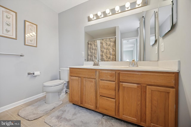 full bathroom with tile patterned floors, double vanity, toilet, and a sink