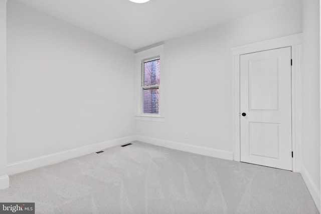 carpeted empty room with baseboards