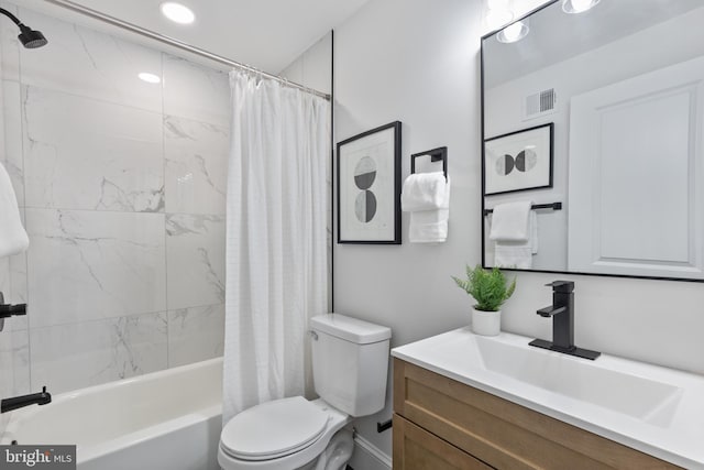 full bath with visible vents, shower / bath combo with shower curtain, toilet, and vanity