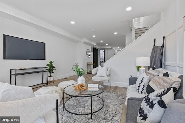 living area with stairway, recessed lighting, light wood-style flooring, and baseboards