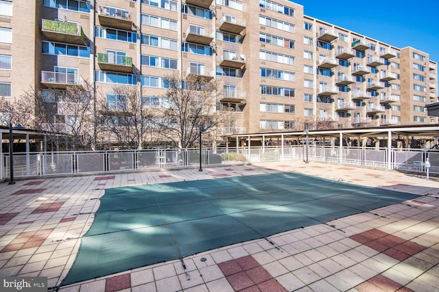 view of pool featuring fence