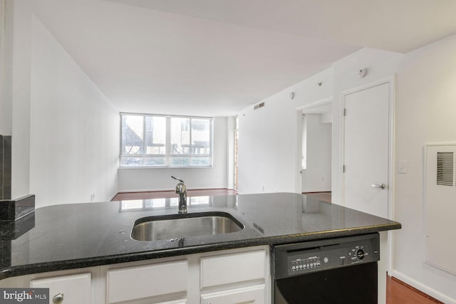 kitchen featuring visible vents, a sink, dark stone countertops, black dishwasher, and white cabinets