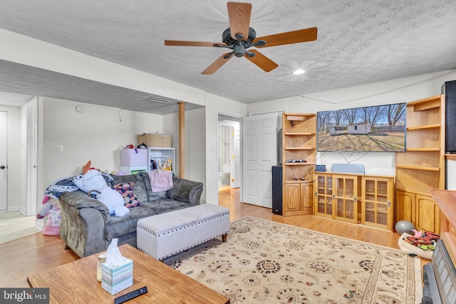 living area with a textured ceiling and wood finished floors