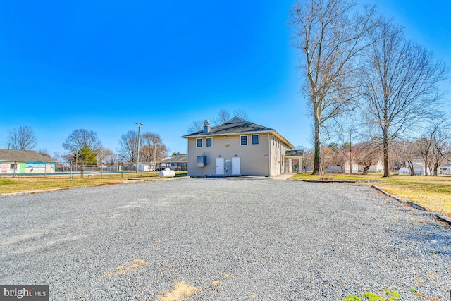 view of front of property with an attached garage and a chimney