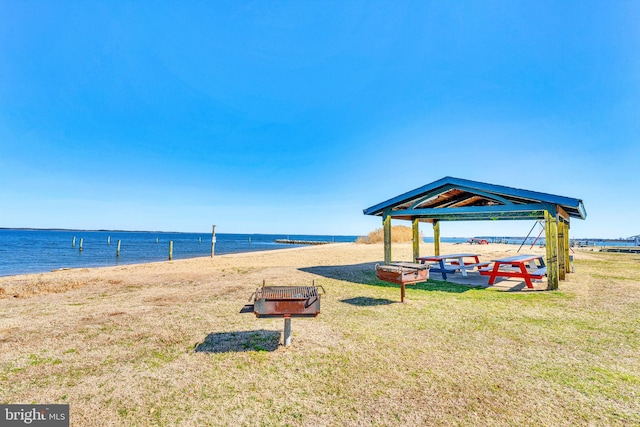 water view featuring a gazebo and a beach view