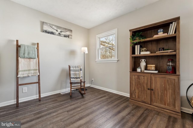 living area with dark wood finished floors and baseboards