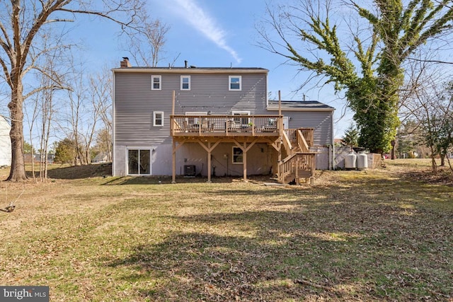 rear view of property with a wooden deck, stairs, central AC, a lawn, and a chimney