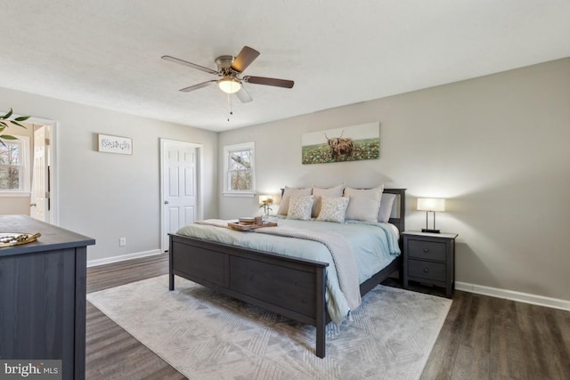 bedroom featuring a ceiling fan, wood finished floors, and baseboards