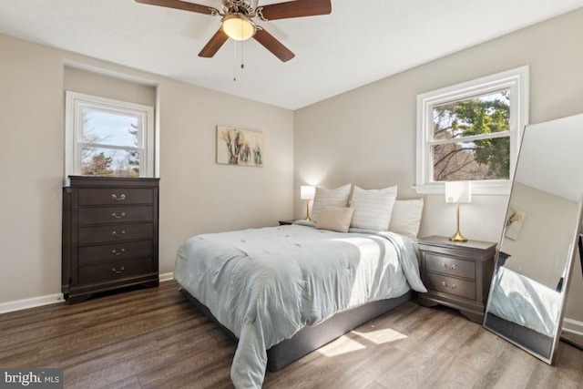 bedroom featuring ceiling fan, baseboards, and wood finished floors