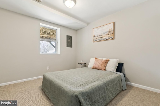 carpeted bedroom featuring electric panel and baseboards