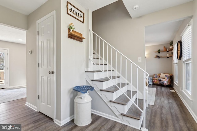 stairs with baseboards and wood finished floors