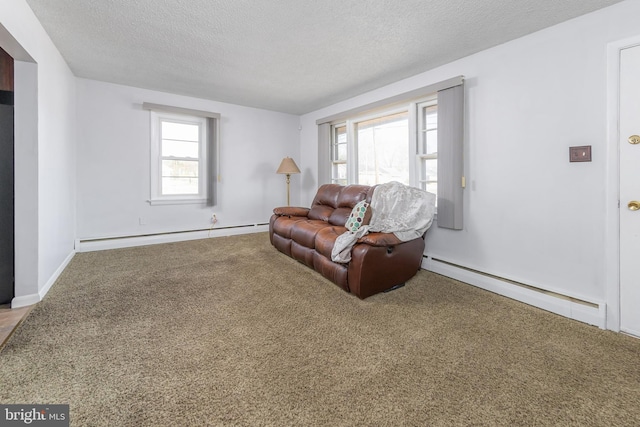 carpeted living area with a baseboard heating unit and a textured ceiling