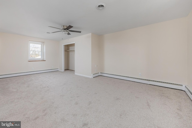 unfurnished bedroom with a baseboard radiator, carpet, visible vents, and a closet