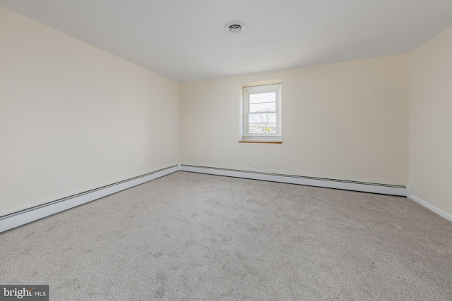 empty room with visible vents, baseboard heating, and carpet